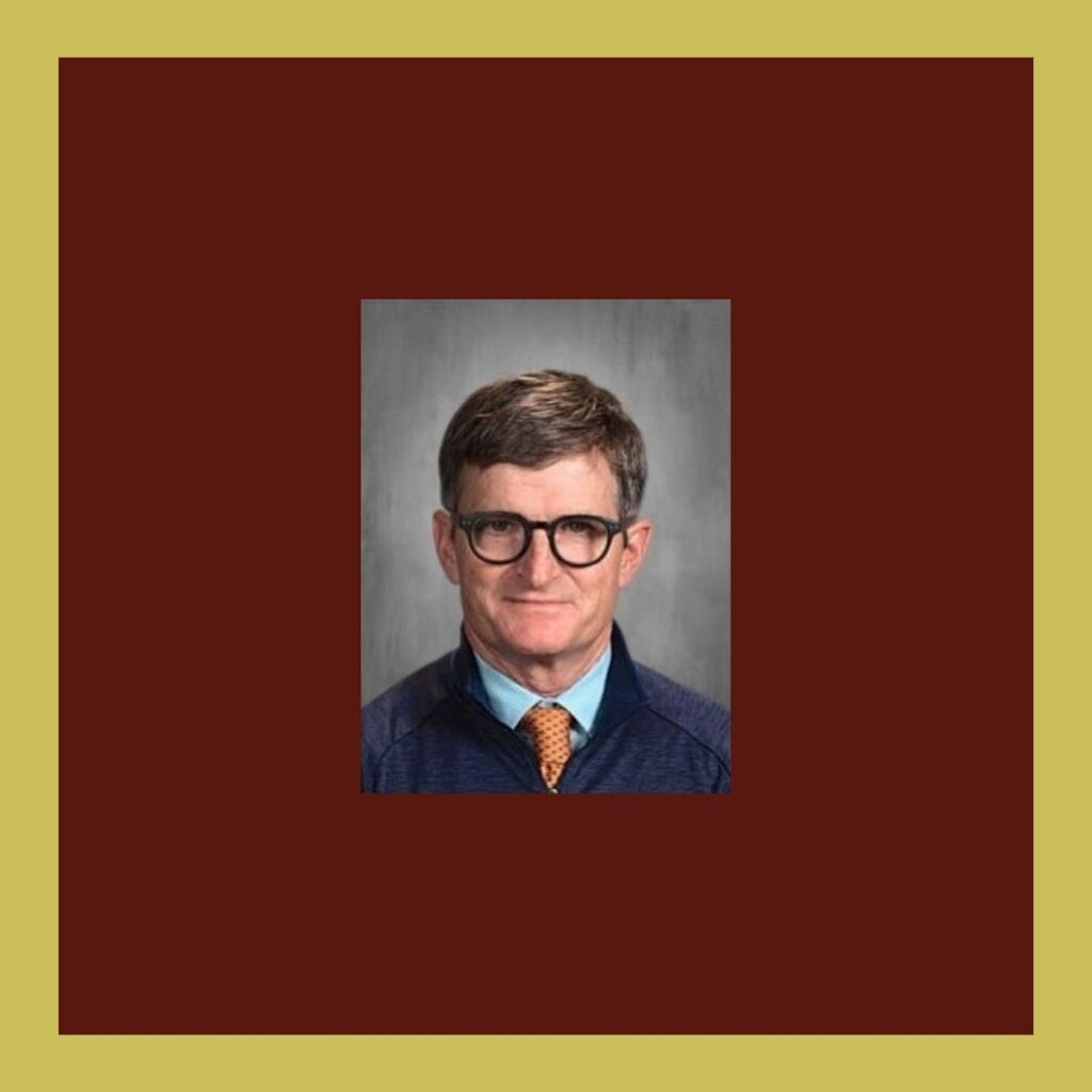 Picture of man in blue shirt and glasses