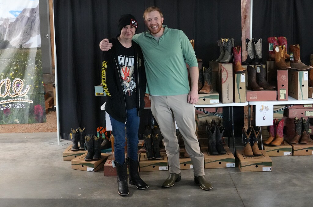 Two men wearing new boots smiling for the camera