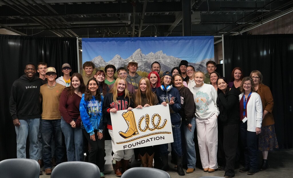 Group of students and staff holding sign that says Jae Foundation