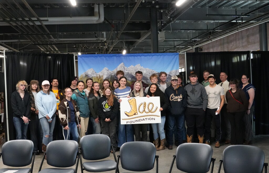 Group of students and staff holding sign that says Jae Foundation