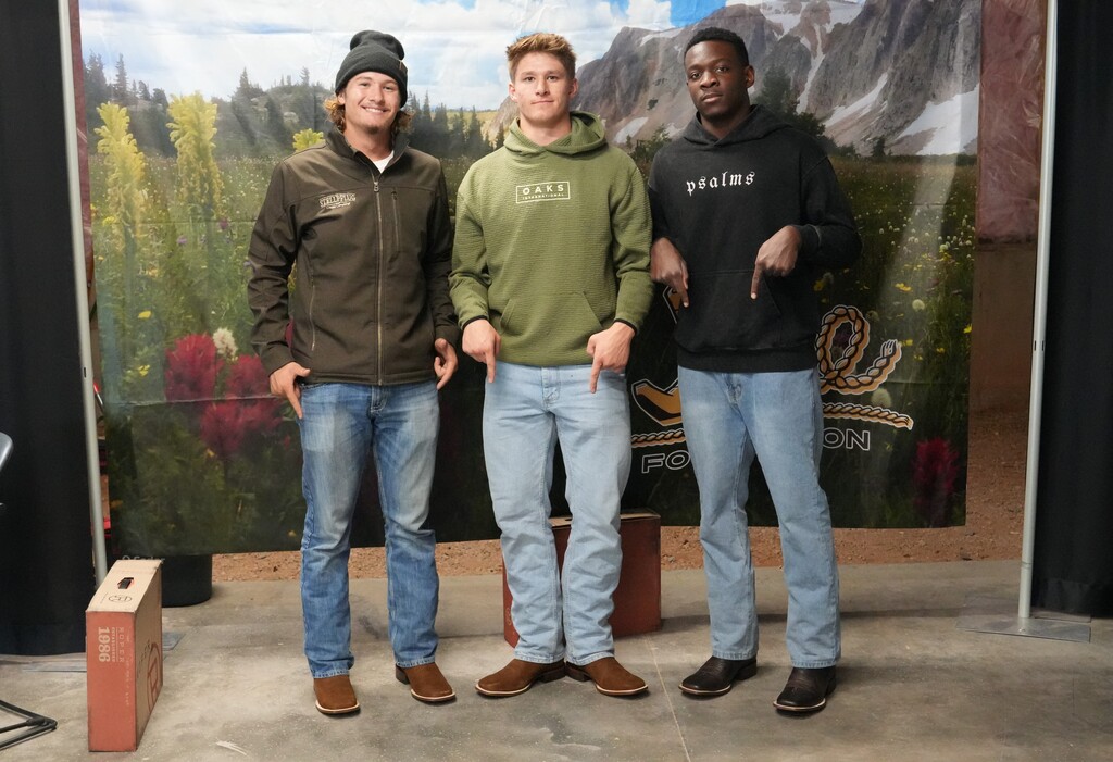 Group of three boys pointing at their new cowboy boots