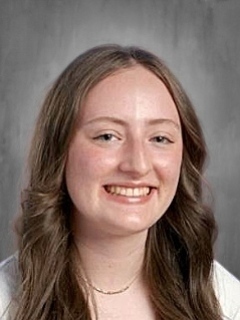 Group of high school students standing in a doorway smiling
