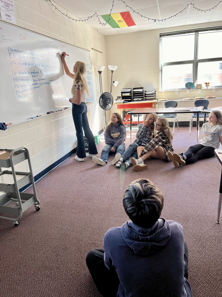 Student writing at the board.