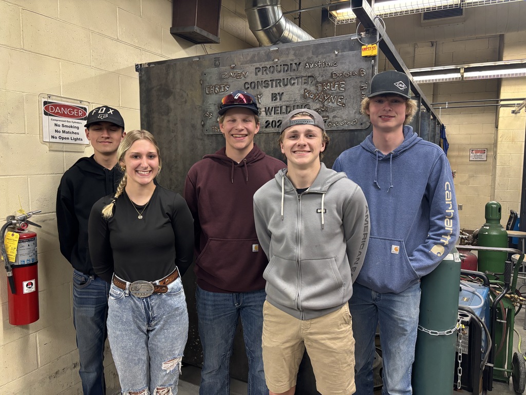 Welding students pose for a photo in the welding lab.