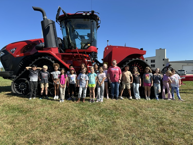group picture by a tractor