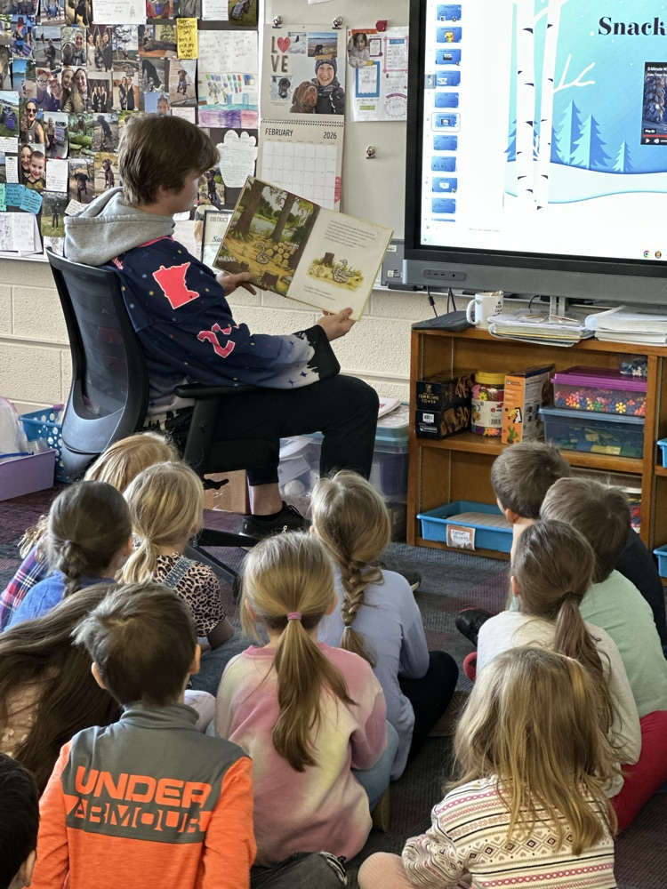 Austin Bruins players reading to elementary students. 