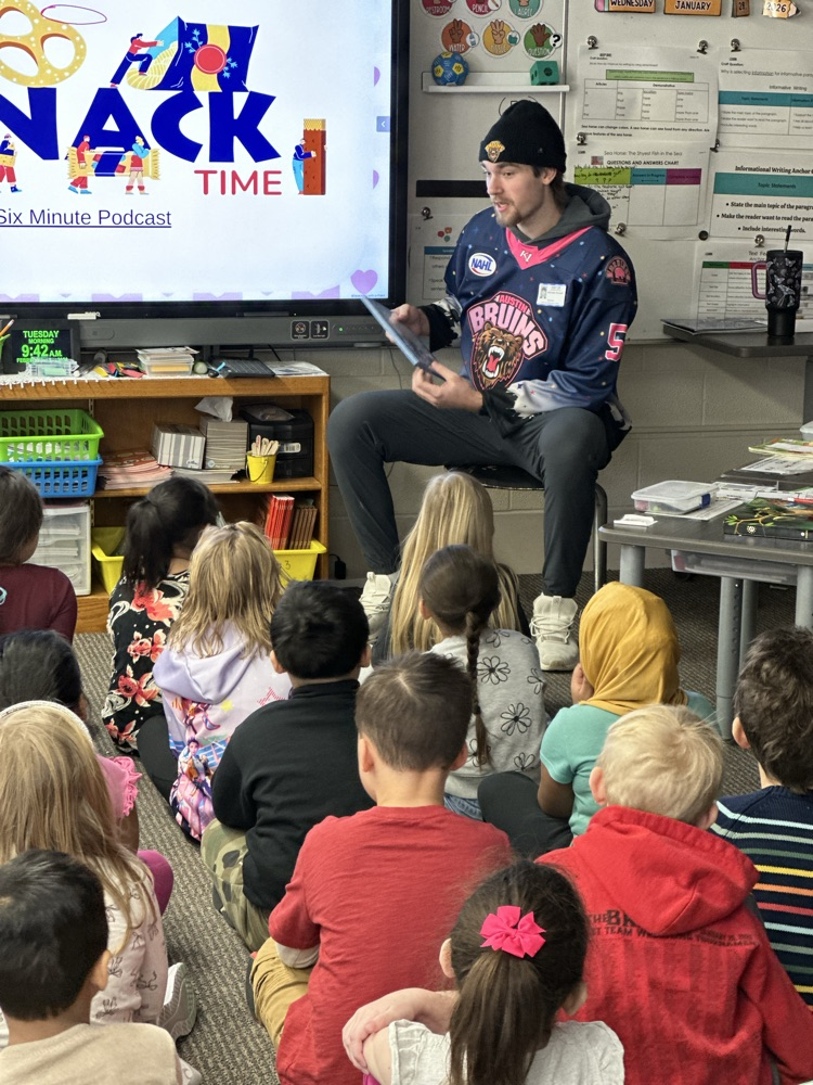 Austin Bruins players reading to elementary students. 