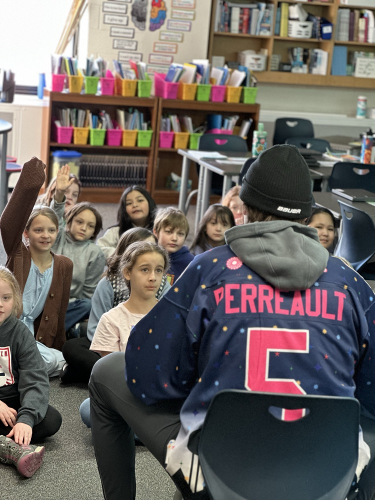 Austin Bruins players reading to elementary students. 