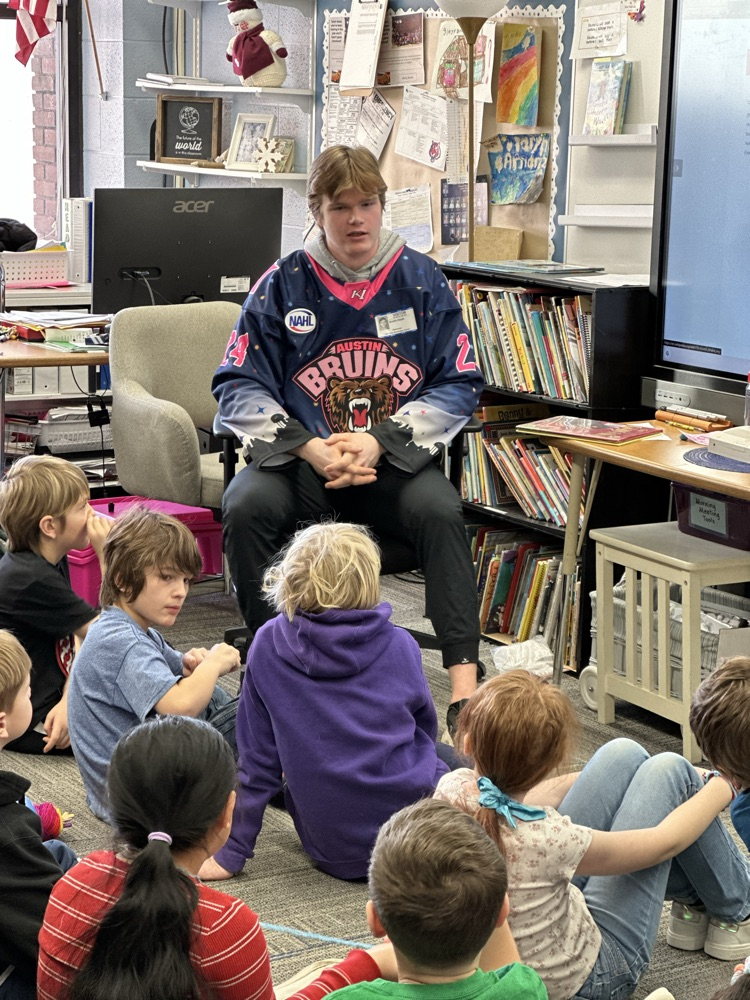 Austin Bruins players reading to elementary students. 
