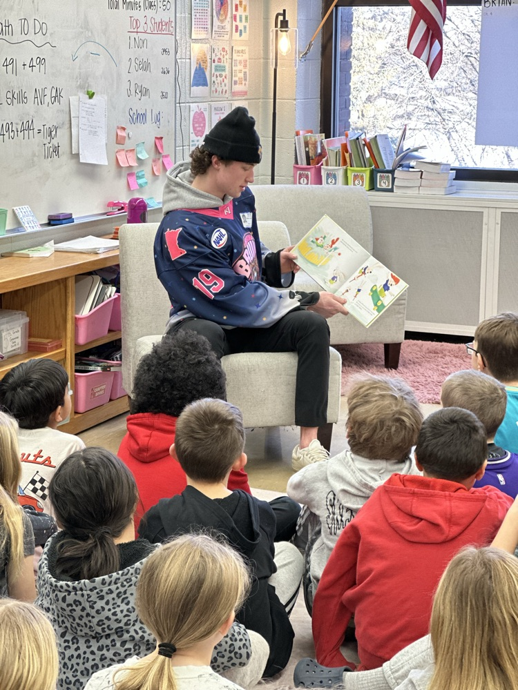 Austin Bruins players reading to elementary students. 