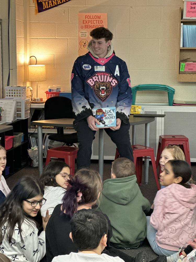 Austin Bruins players reading to elementary students. 