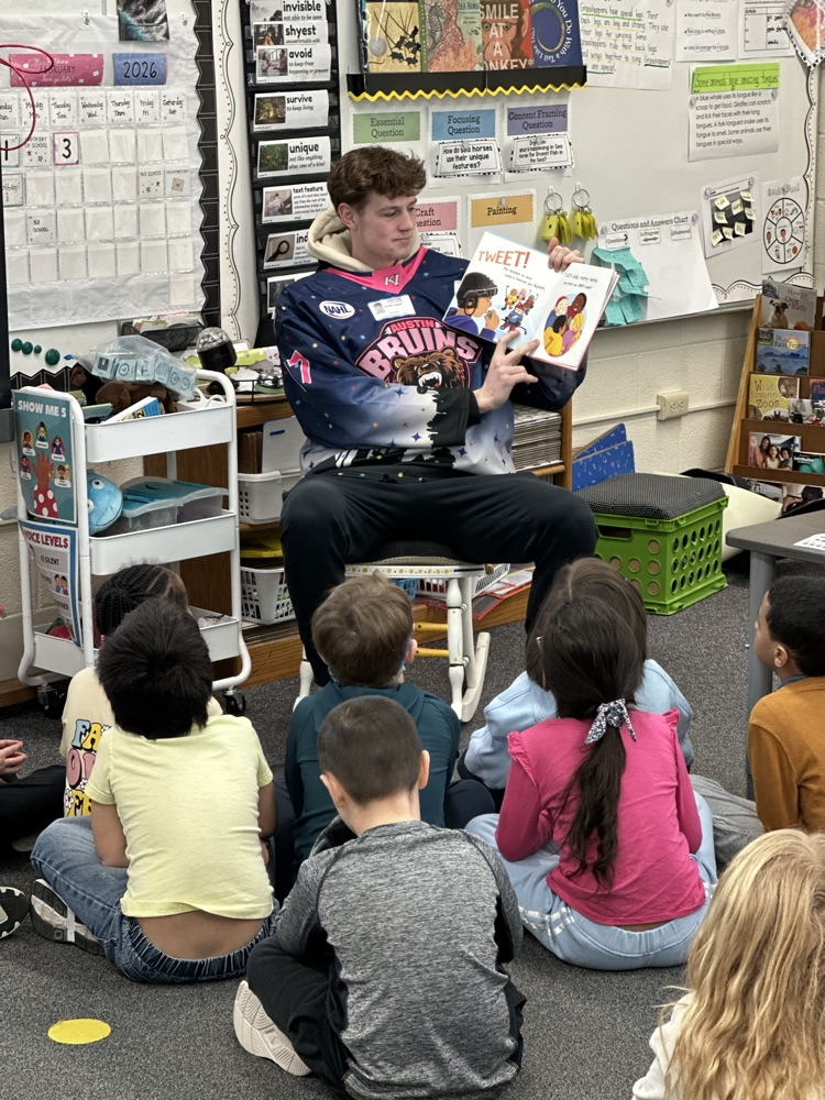 Austin Bruins players reading to elementary students. 