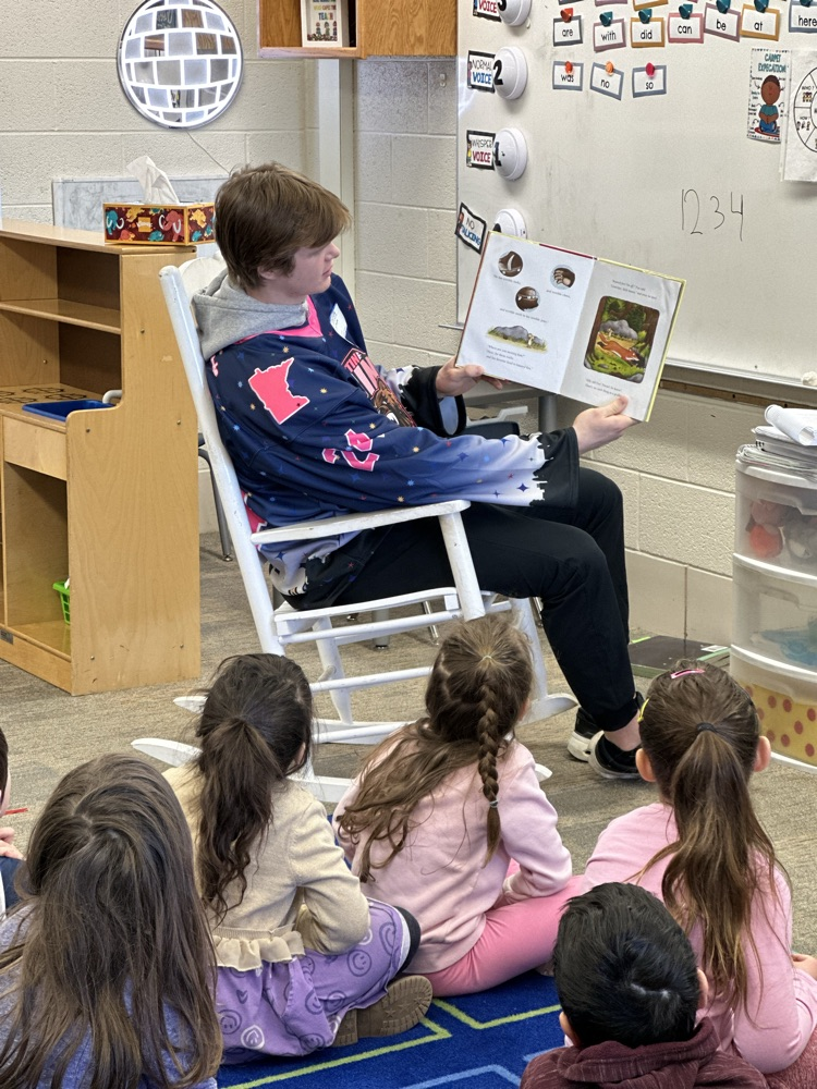 Austin Bruins players reading to elementary students. 