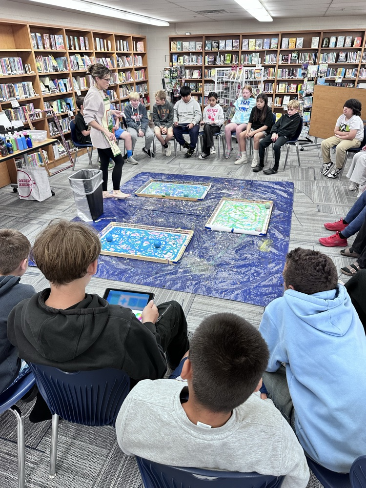 Students painting with robots.