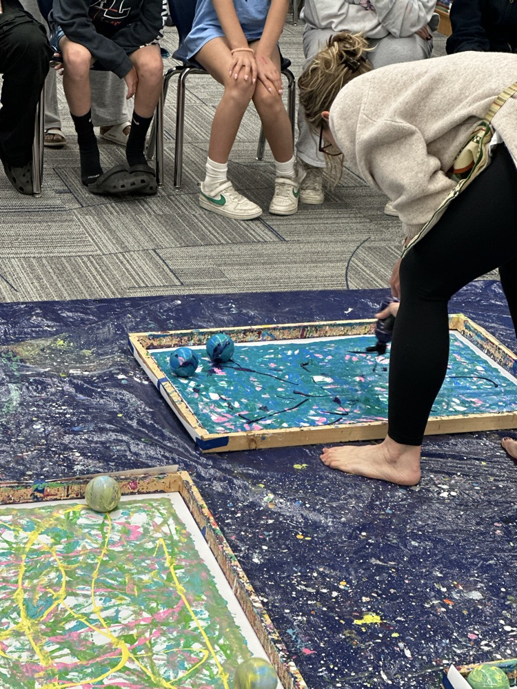 Students painting with robots.