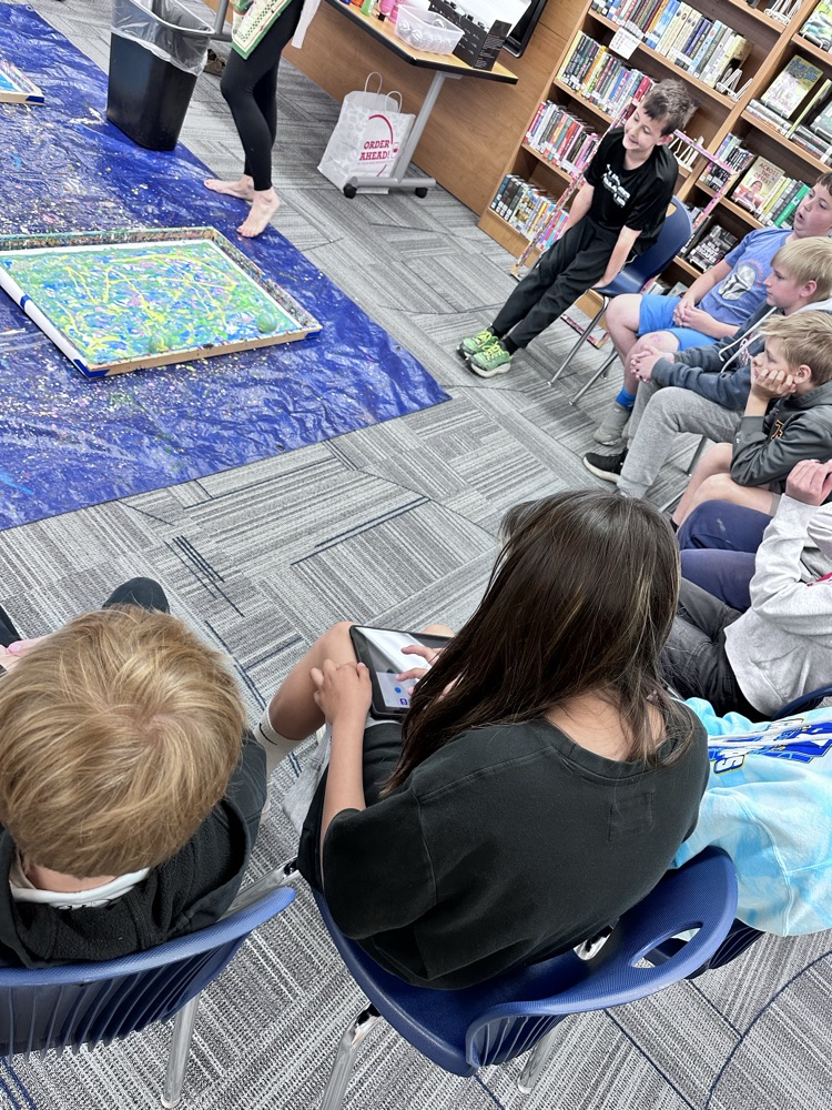 Students painting with robots.