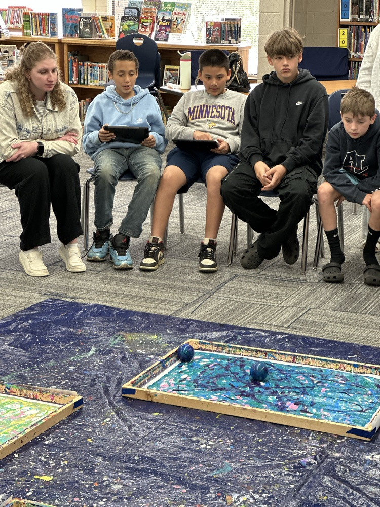 Students painting with robots.