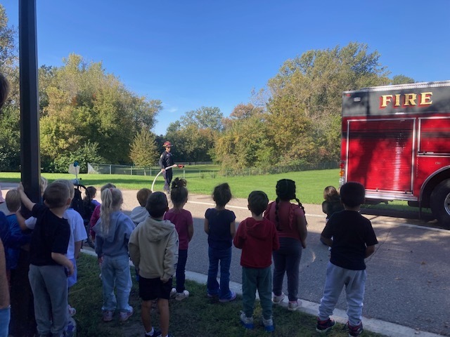 Students watching fire truck demonstration