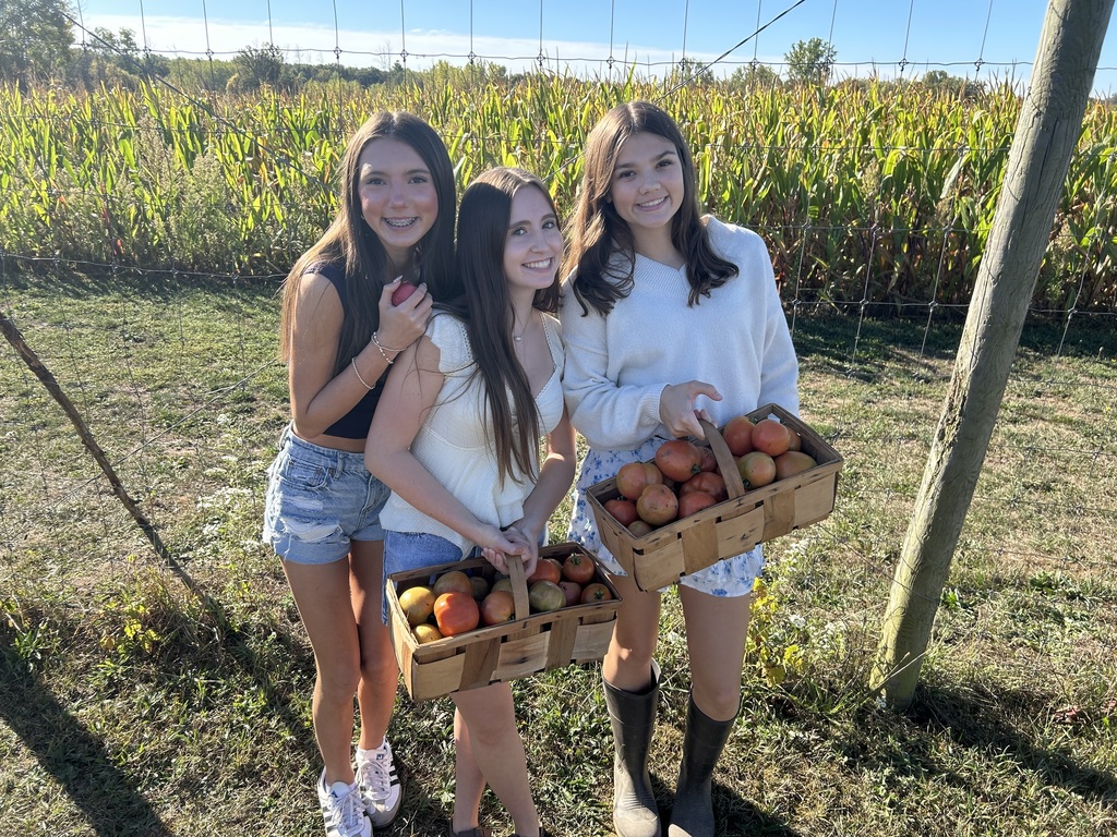 students harvesting vegetables