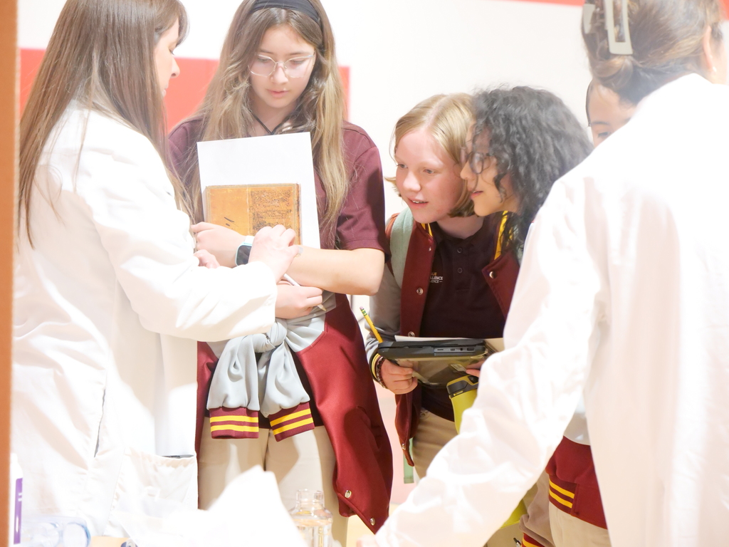 Microbiologists showing students mold petri dish samples