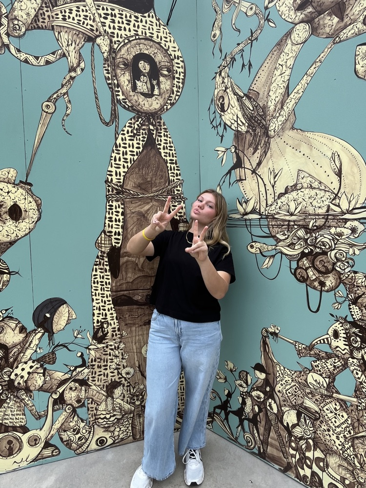 Posing in front of mural art