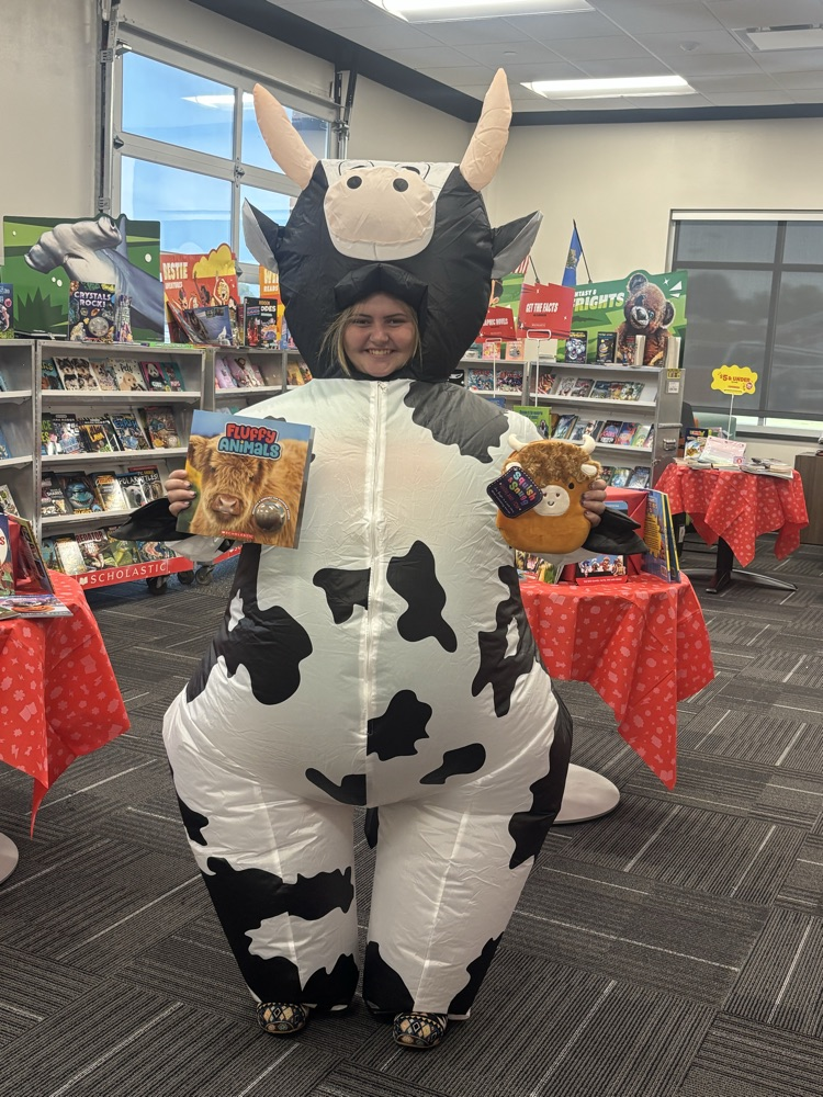 Kayla Venable showing off cow themed goodies at the book fair.