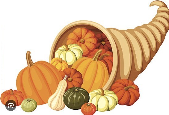 picture of cornicopia with squash of various kinds in it