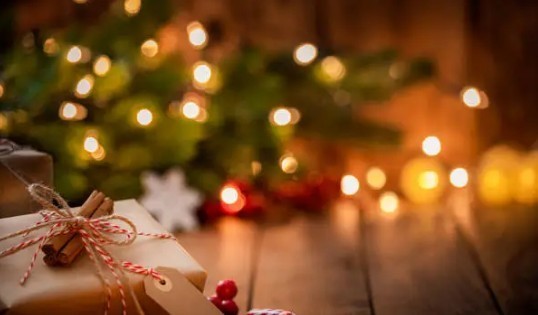 picture of christmas presents under a blurred background of a lighted christmas tree