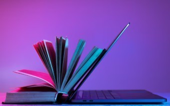 picture of a text book and a computer