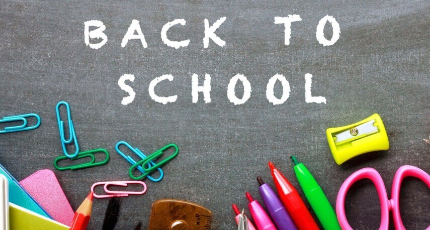 picture with school supplies against a backdrop of a chalkboard with the words back to school written on it