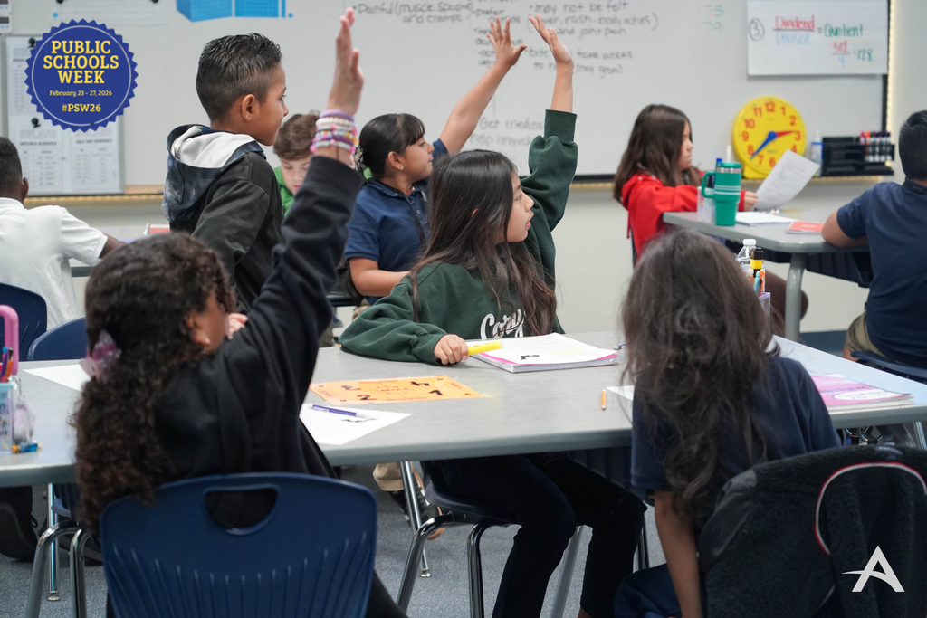Students in classroom raising their hand 