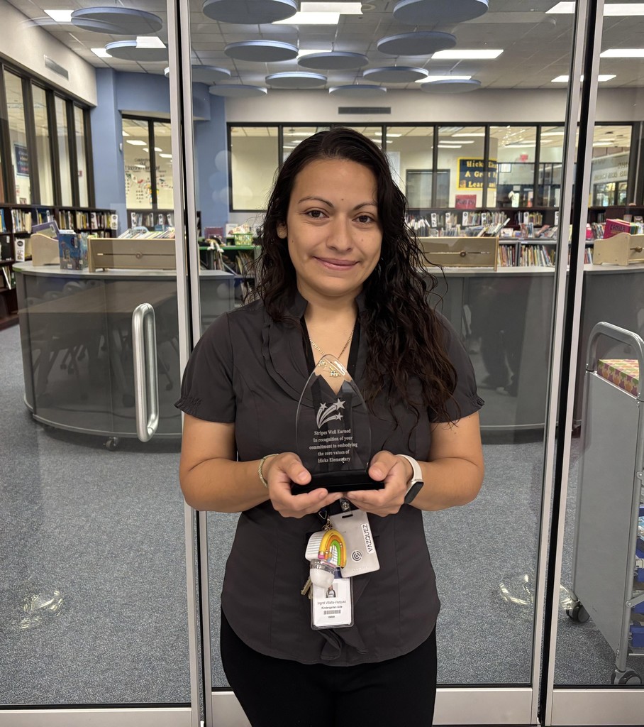 Staff member holding award