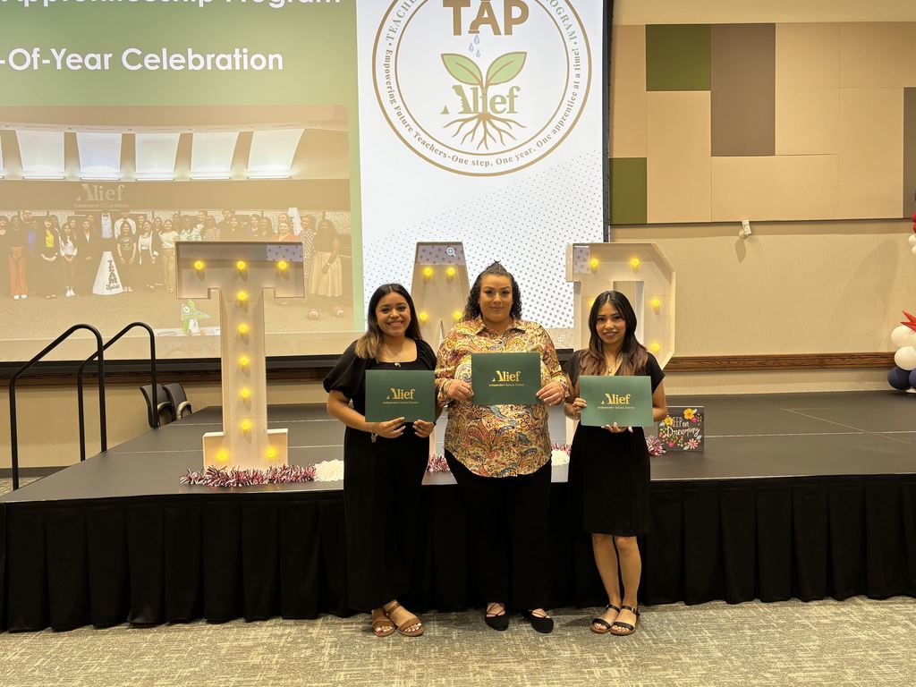 Three women on a stage with a large screen behind them displaying "TAP 10-Year Celebration". They hold certificates.