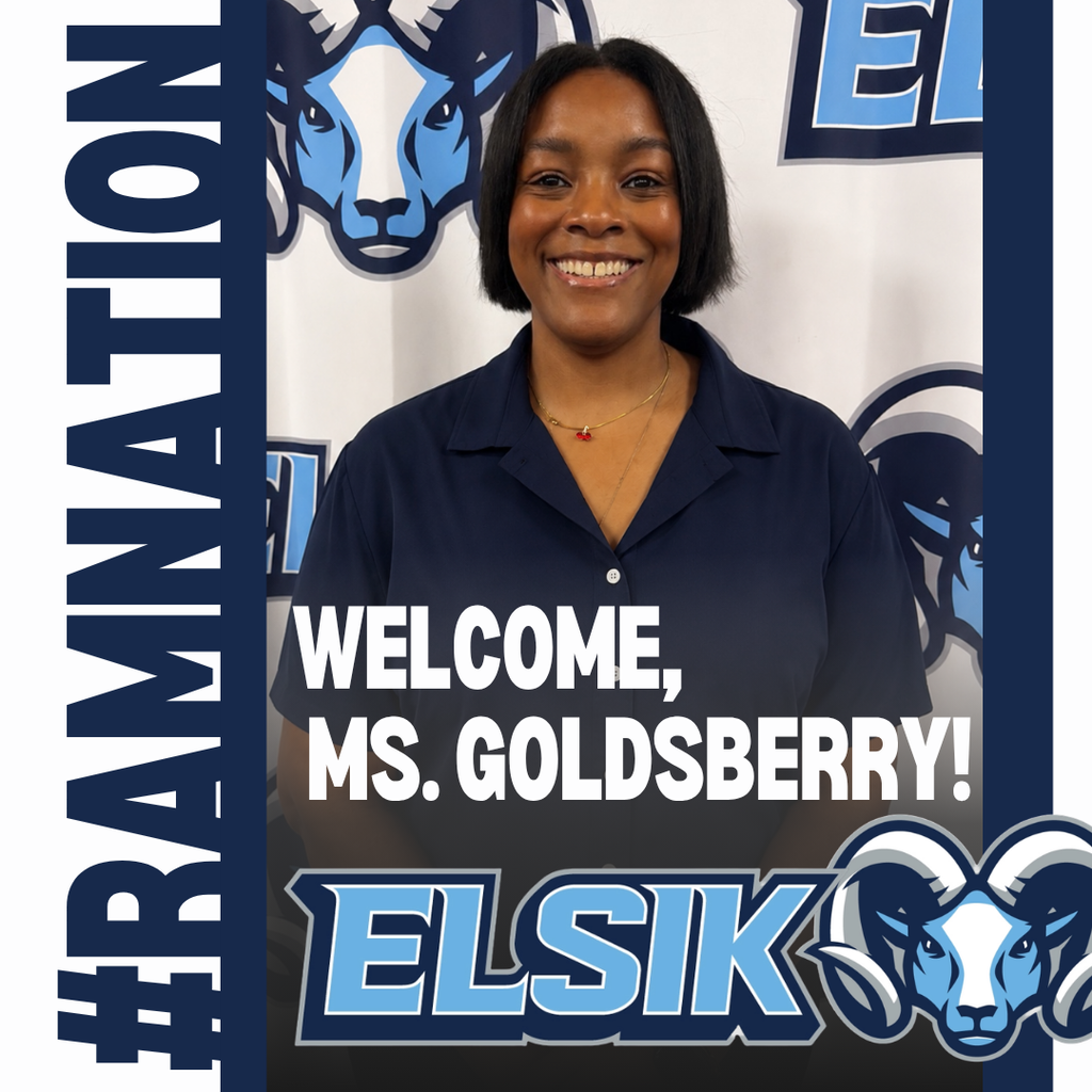 A smiling woman stands before a backdrop with a ram logo. She wears a blue polo shirt.