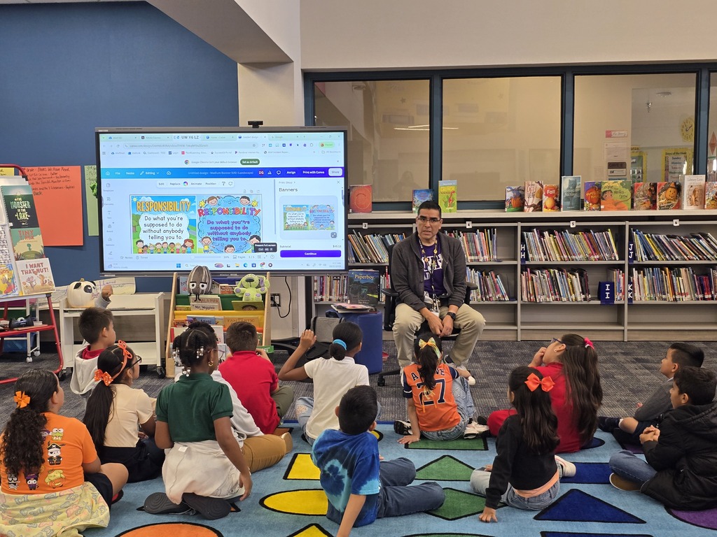 School counselor Mr. Garcia leads a lesson on responsibility as Rees PVAA students sit on the library rug and participate in a discussion.