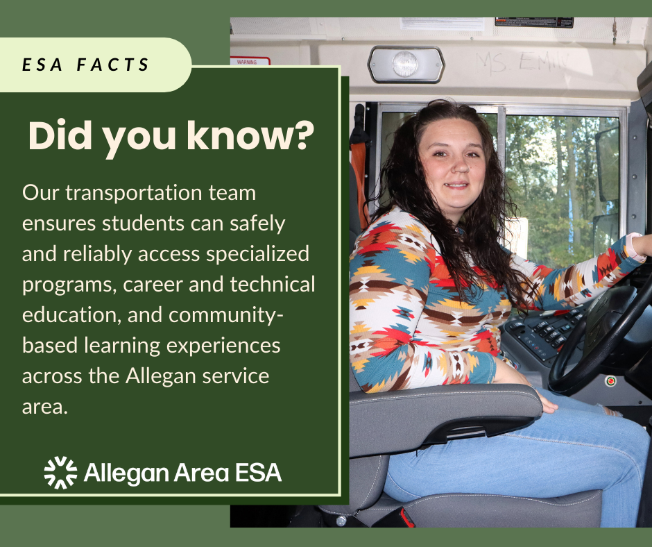 female bus driver sitting in driver's seat smiling.