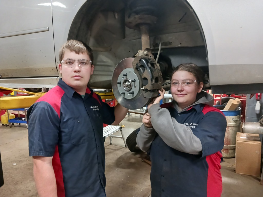 Students working on a car wheel