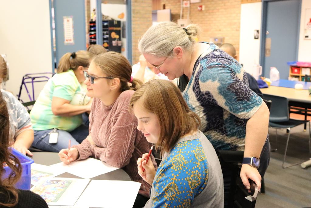 A teacher observes two students drawings
