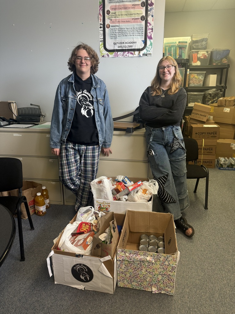 two Outlook Academy students standing next to the generous donations from Hillside, AAESA, and Allegan County Tech Center