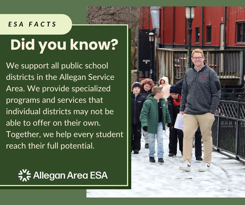 A male teacher walking down snowy path with a group of students