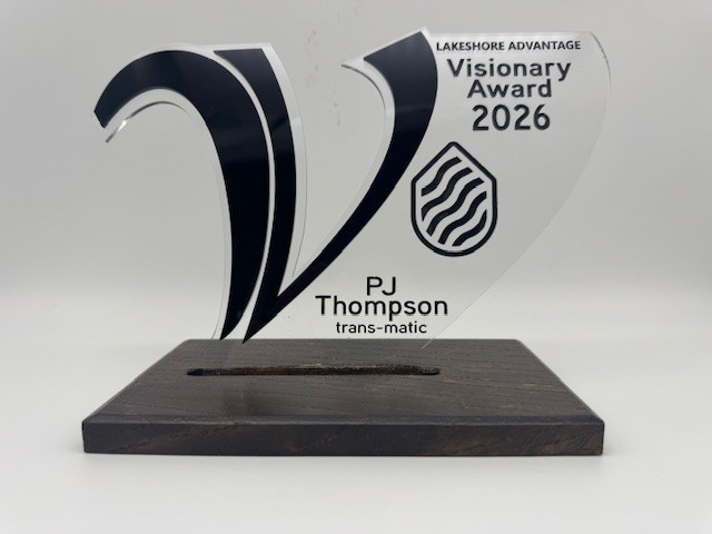 A photo of the award which is a large V, with the words Lakeshore Advantage Visionary Award 2026 and this award is for PJ Thompson trans-matic