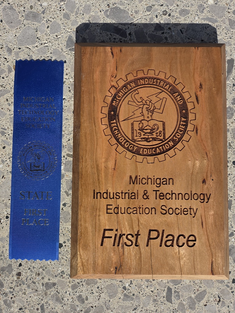 Photo of the blue ribbon and wooden plaque that reads Michigan Industrial & Technology Education Society First Place
