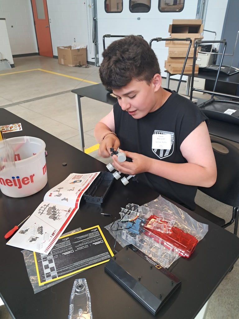 These small engine models are similar to Lego kits. Here, a student has the instructions in front of him as he follows step-by-step.