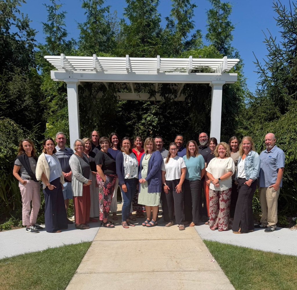 ad council members smile outside in a group photo.