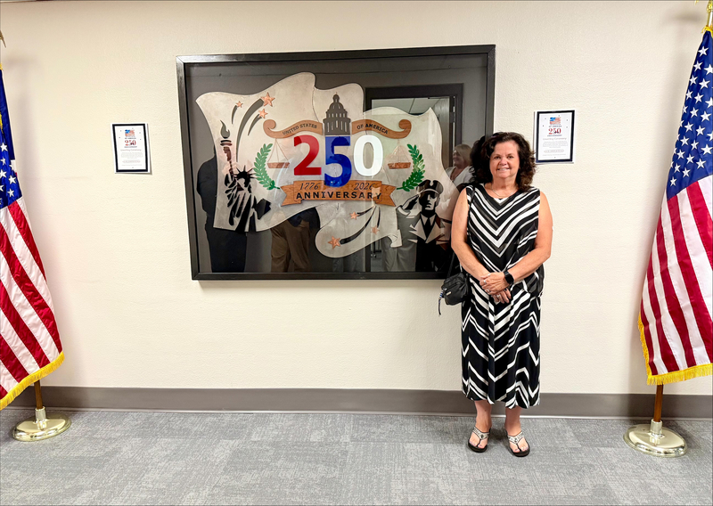 Graphic design teacher in front of artwork