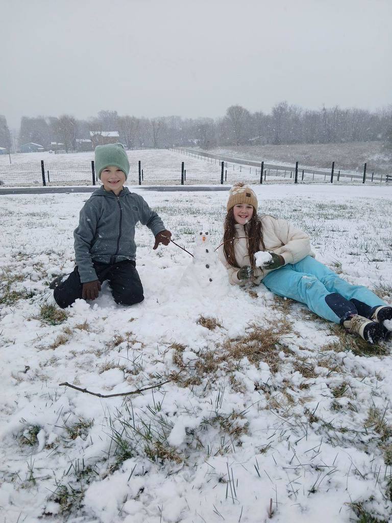 students playing in the snow