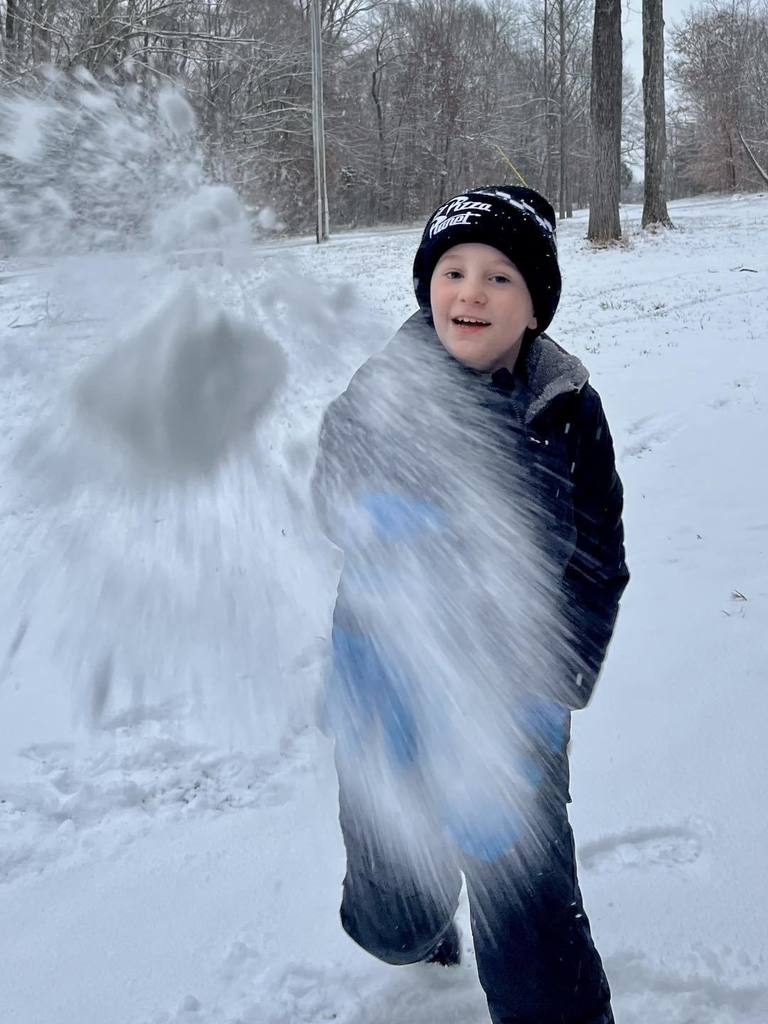 students playing in the snow