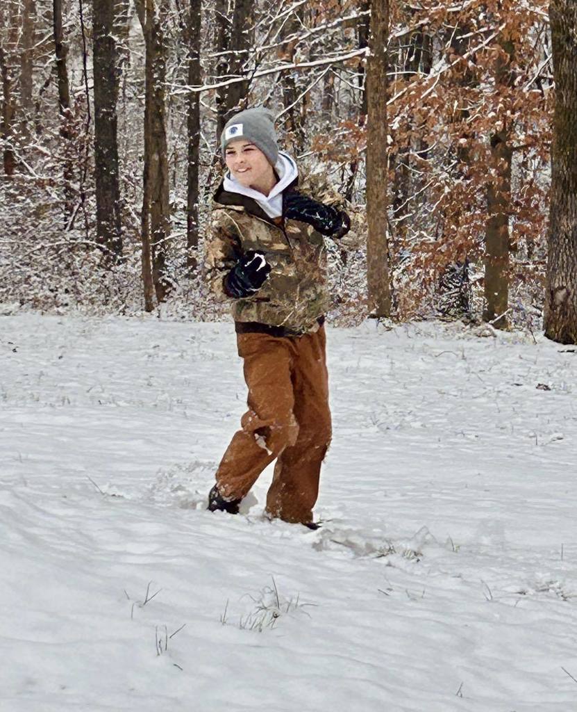 students playing in the snow
