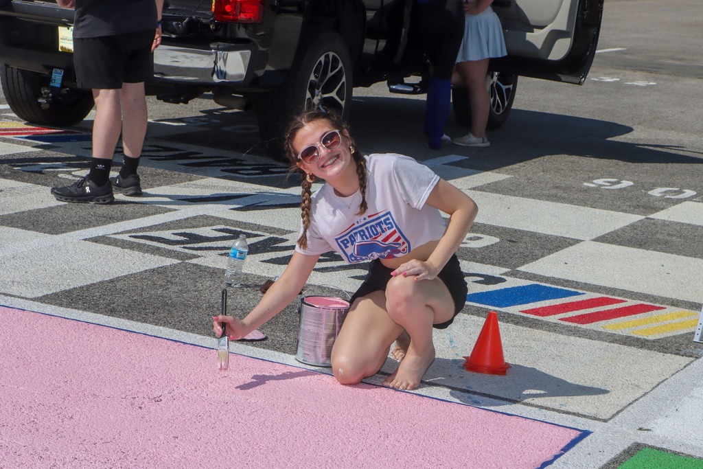 students paint senior parking spots