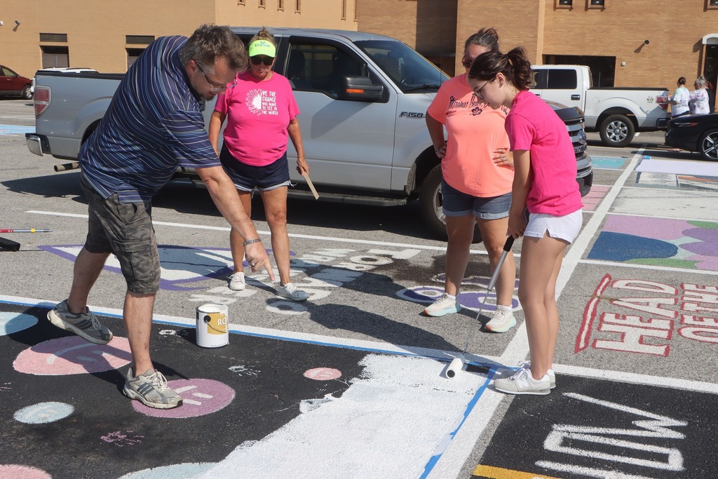students paint senior parking spots